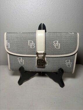 Dooney & Bourke black and white signature monogram lock flap wallet.
